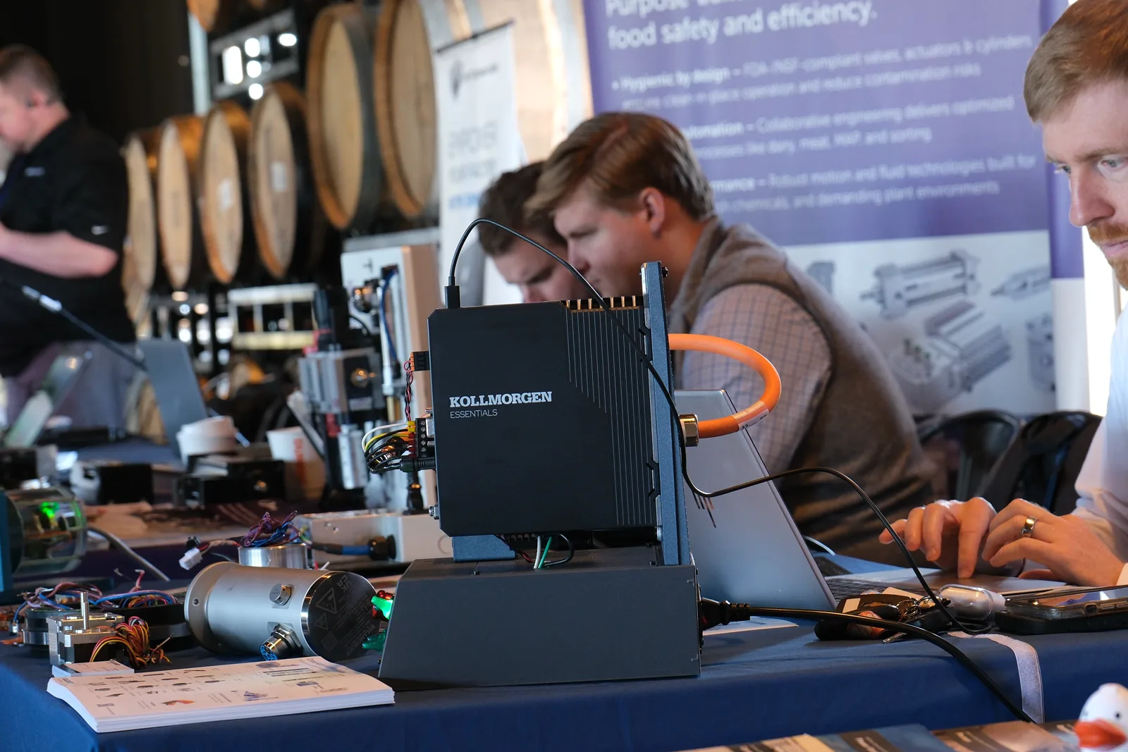 Attendees testing equipment hands-on at a demo table